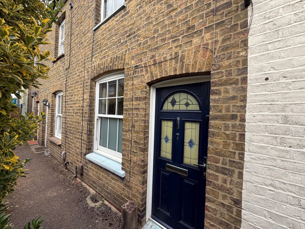 Lot: 76 - TWO-BEDROOM MID-TERRACE HOUSE FOR IMPROVEMENT - External front shot of property